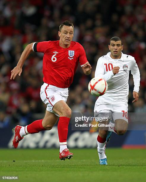 John Terry of England gives chase with Emad Abdelnaby of Egypt during the International Friendly match between England and Egypt at Wembley Stadium...