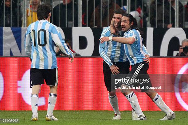 Gonzalo Higuain of Argentina celebrates the first goal with Jonás Gutiérrez of Argentina and Lionel Messi during the International Friendly match...