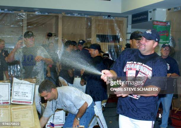 Atlanta Braves pitcher Steve Reed sprays the club house with champagne after the Braves clinched the National League East title with a 20-3 win over...