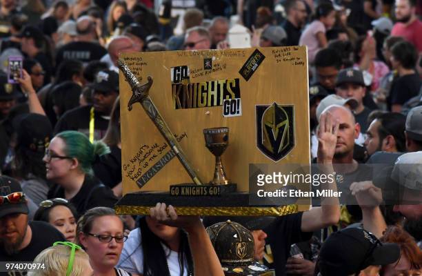 Vegas Golden Knights fan holds up a wooden sign during the team's "Stick Salute to Vegas and Our Fans" event at the Fremont Street Experience on June...