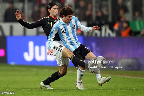 Serdar Tasci of Germany tackles Lionel Messi of Argentina during the International Friendly match between Germany and Argentina at the Allianz Arena...