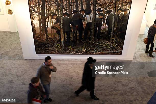 People walk by the painting by Vincent Desiderio entitled 'Mourning and Fecundity' at the Armory Show on March 3, 2010 in New York, New York. The...