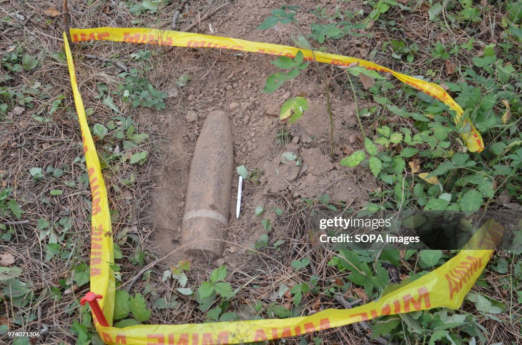 An unexploded shell is outlined with tape during a clearance...