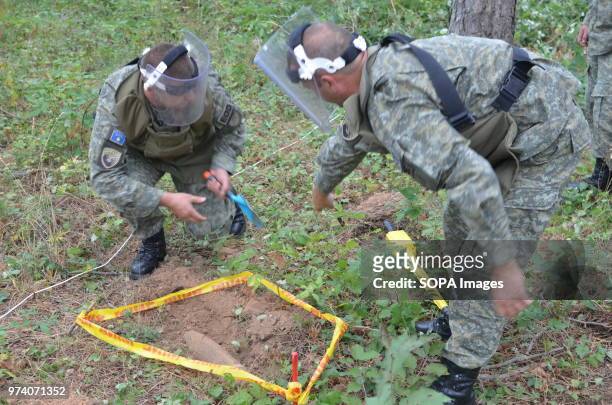 An unexploded shell is outlined with tape during a clearance operation by the Kosovo Security Force Emergency Ordinance Disposal team in Freedom Park...