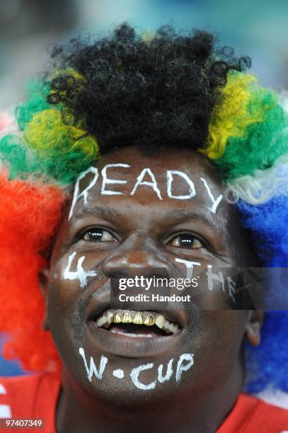 In this handout image provided by the 2010 FIFA World Cup Organising Committee for South Africa,, A South African fan attends the International...