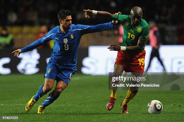 Marco Borriello of Italy battles for the ball with Stephane Mbia of Cameroon during the International Friendly match between Italy and Cameroon at...