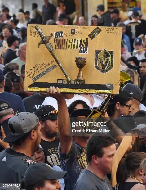 Vegas Golden Knights fan holds up a wooden sign during the team's "Stick Salute to Vegas and Our Fans" event at the Fremont Street Experience on June...