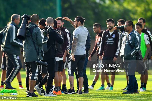 Singer Maluma talks with players of Mexico team during a training session at FC Strogino Stadium on June 12, 2018 in Moscow, Russia.