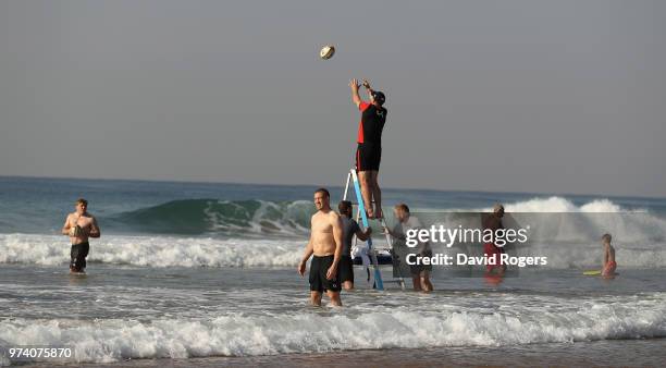 Steve Borthwick, the England forwards coach, catches the ball as he practices lines outs in the Indain Ocean during the England recovery session held...