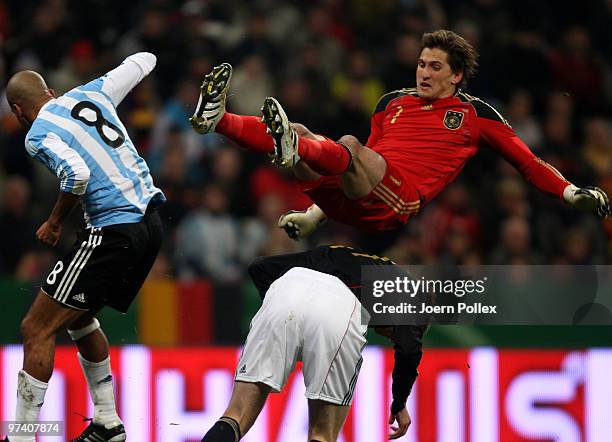 Per Mertesacker and Rene Adler of Germany and Juan Sebastian Veron of Argentina compete for the ball during the International Friendly match between...