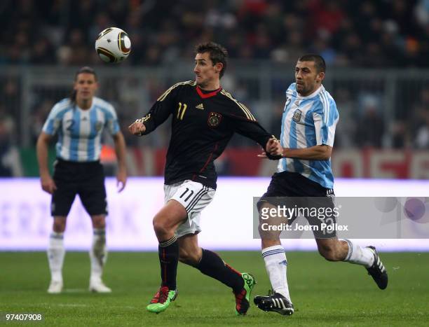 Miroslav Klose of Germany and Walter Samuel of Argentina battle for the ball during the International Friendly match between Germany and Argentina at...