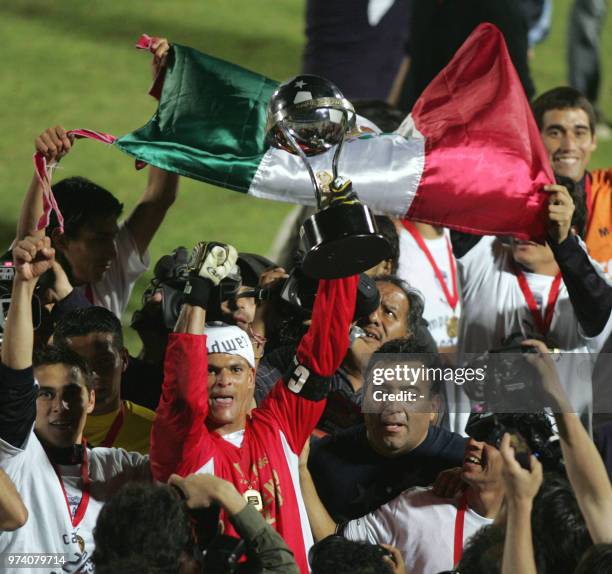 Mexico s Pachuca Goalkeeper Miguel Angel Calero raises the trophy after the defeating Chile's Colo Colo in their South American Cup match in...