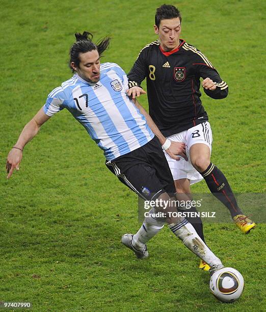 Argentina's midfielder Jonás Gutiérrez and Germany's midfielder Mesut Oezil vie for the ball during the friendly football match Germany vs Argentina...