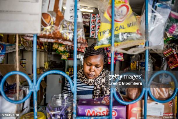 Janeffer Wacheke, co-owner of a fresh-vegetable stall, waits for costumers at her stall in Nairobi, Kenya, on June 11, 2018. Wacheke's...