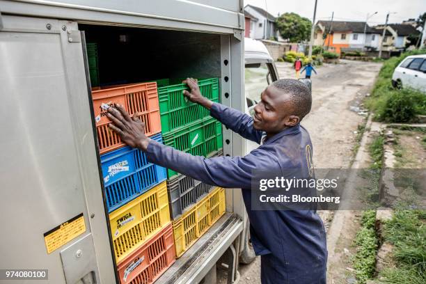 An employee of Twiga Foods Ltd. Stacks crates in his truck after delivering produce to a stall selling general goods and fresh vegetables in Nairobi,...