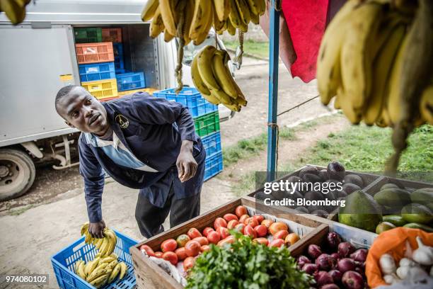 An employee of Twiga Foods Ltd. Delivers bananas to a stall selling general goods and fresh vegetables in Nairobi, Kenya, on June 11, 2018....