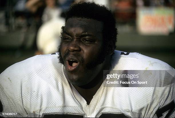 Offensive tackle Art Shell of the Oakland Raiders watches the action from the bench circa 1970's during an NFL football game. Shell played for the...