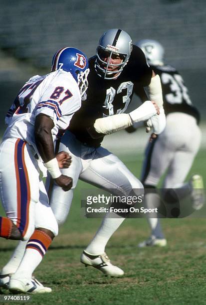 S: Linebacker Ted Hendricks of the Los Angeles Raiders in action guarding tight end James Wright of the Denver Broncos circa early 1980's during an...