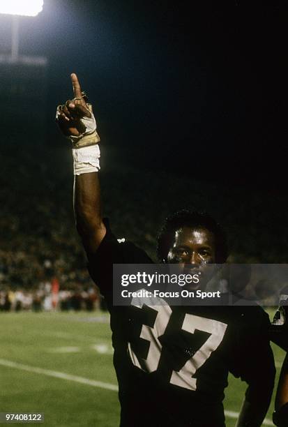 Defensive back Lester Hayes of the Los Angeles Raiders on the sideline indicating the Raiders are number one as they are on their way to defeat the...