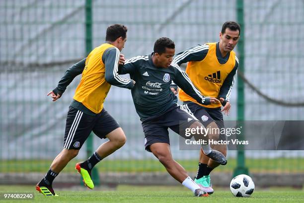 Andres Guardado, Giovani dos Santos and Rafael Marquez of Mexico, struggles for the ball the ball during a training session at team training base...