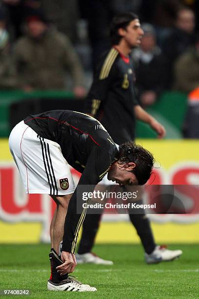 Serdar Tasci and Sami Khedira of Germany look dejected after losing 0-1 the International Friendly match between Germany and Argentina at the Allianz...