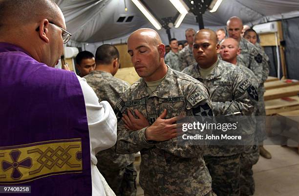 Army Priest Cpt. Carl Subler , blesses non-denominational chaplain Cpt. Gary Lewis , after conducting a Catholic Mass on March 3, 2010 at Forward...