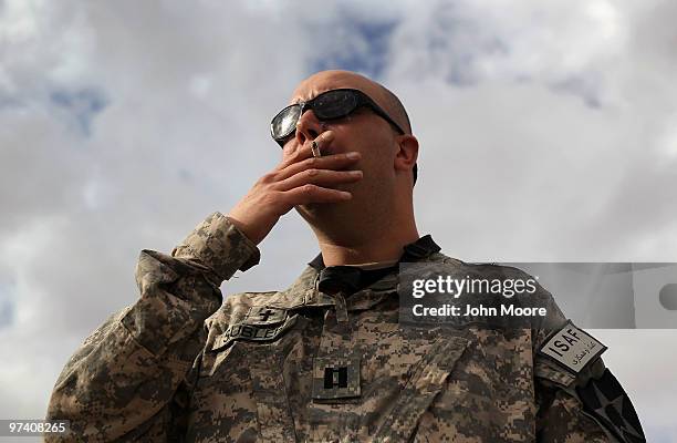 Army Chaplain Carl Subler awaits helicopter transport from Kandahar Air Field on March 3, 2010 to visit soldiers at Forward Operating Base Frontenac...