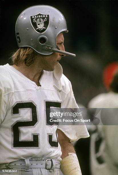 Wide Receiver Fred Biletnikoff of the Oakland Raiders watches the action from the sidelines circa early 1970's during an NFL football game....