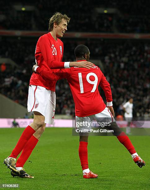 Peter Crouch of England celebrates with Shaun Wright-Phillips as he scores their third goal during the International Friendly match between England...