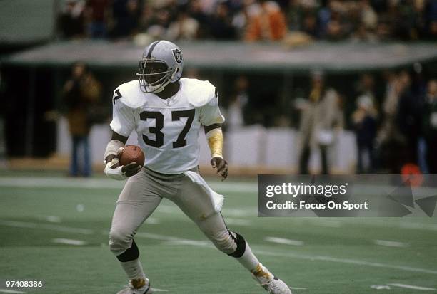 S: Defensive back Lester Hayes of the Oakland Raiders in action running back an interception against the Pittsburgh Steelers circa early 1980's...