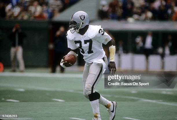 S: Defensive back Lester Hayes of the Oakland Raiders in action running back an interception against the Pittsburgh Steelers circa early 1980's...