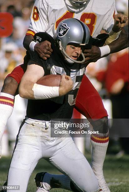 S: Wide Receiver Fred Biletnikoff of the Oakland Raiders after catching a pass has his back jumped on by defensive back Nate Allen of the Kansas City...