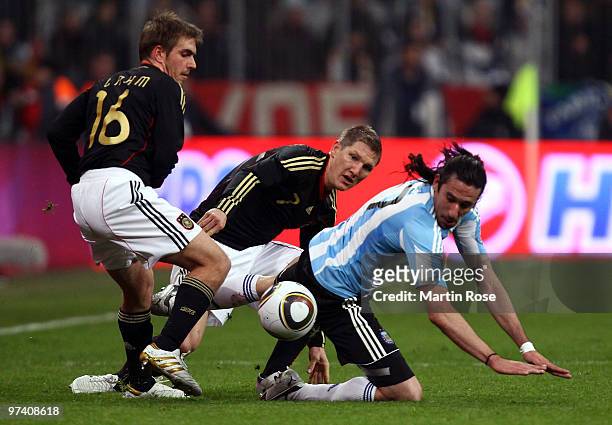 Bastian Schweinsteiger of Germany and Jonas Gutierrez of Argentina compete for the ball during the International Friendly match between Germany and...