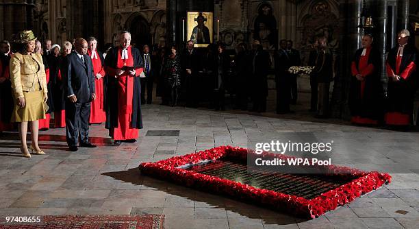 South Africa's President Jacob Zuma , wife Thobeka Madiba Zuma and Dean of Westminster Abbey, Reverend John Hall stand in front of the tomb of The...