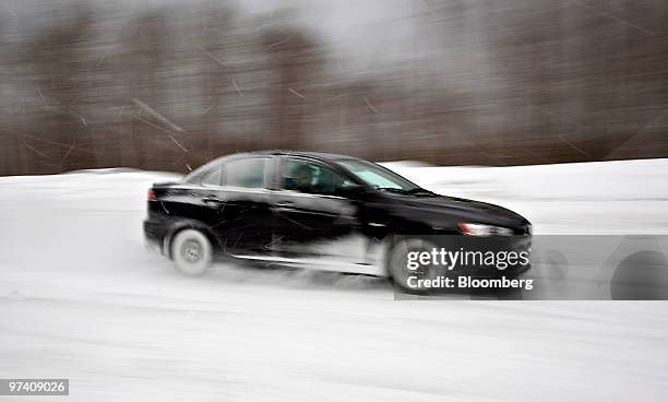Mitsubishi Lancer Evolution MR is driven on a snowy skid pad at Team O'Neil Rally School & Car Control Center in Dalton, New Hampshire, U.S., on...