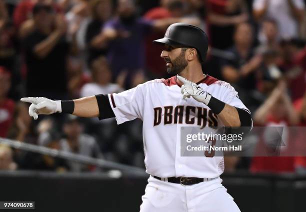 Daniel Descalso of the Arizona Diamondbacks gestures to his teammates in the dugout against the Pittsburgh Pirates at Chase Field on June 11, 2018 in...