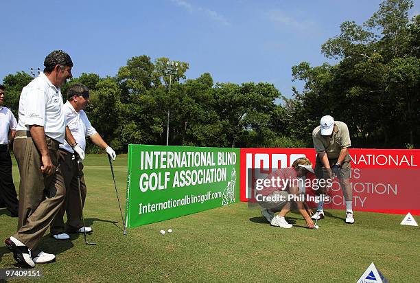 Sam Torrance of Scotland and Ian Woosnam of Wales watch a blind man play golf prior to the start of the Aberdeen Brunei Senior Masters presented by...