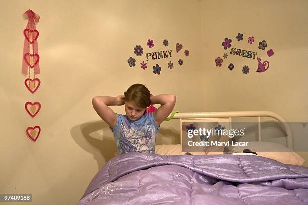 Victoria Forhetz, 13 prepares for bed after an evening at the church where she and her family participated in a purity ring ceremony on February 13,...