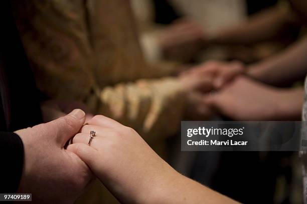 Parents place rings on their sons and daughters who participated in the purity ring ceremony on February 13, 2008 at the Full Life Assembly of God in...