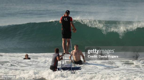 Steve Borthwick, the England forwards coach, catches the ball as he practices lines outs in the Indain Ocean during the England recovery session held...