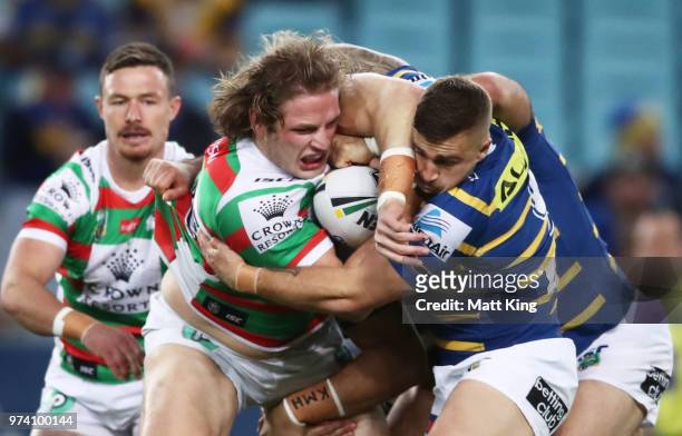 George Burgess of the Rabbitohs is tackled during the round 15 NRL match between the Parramatta Eels and the South Sydney Rabbitohs at ANZ Stadium on...