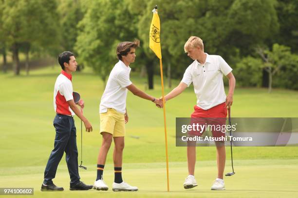 Alejandro Aguilera Martin of Spain and Sebastian Friedrichsen of Denmark shake hands during the third round of the Toyota Junior Golf World Cup at...