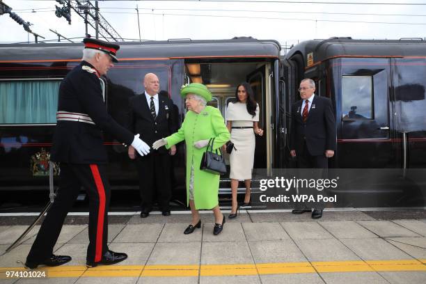 Queen Elizabeth II is greeted with Meghan, Duchess of Sussex as they arrive by Royal Train at Runcorn Station to open the new Mersey Gateway Bridge...