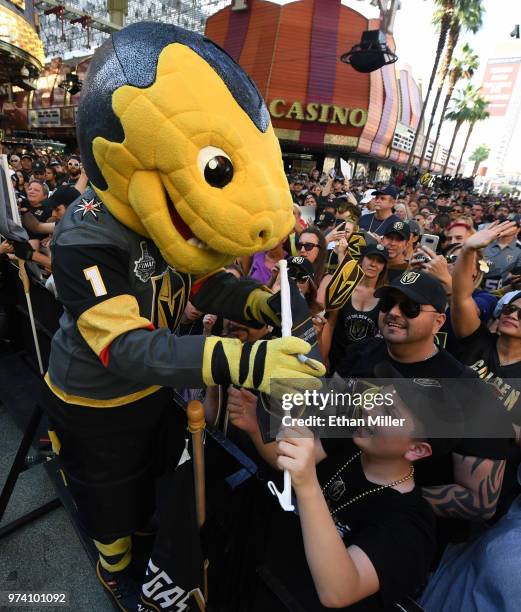 The Vegas Golden Knights mascot Chance the Golden Gila Monster signs autographs for fans during the team's "Stick Salute to Vegas and Our Fans" event...