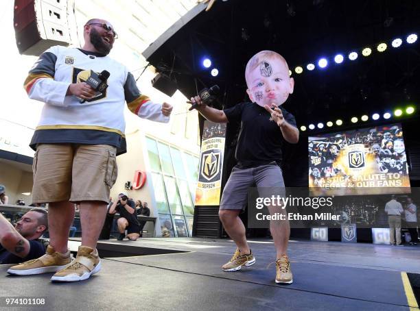 Vegas Golden Knights hosts Wayne "Big D" Danielson and Mark Shunock joke around with a fan's Halloween baby mask during the team's "Stick Salute to...