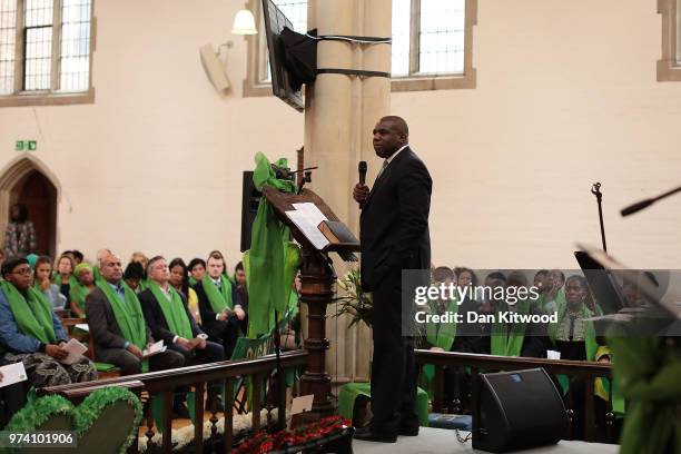 The congregation listen to Labour Party MP for Tottenham, David Lammy give a speech during a memorial service at St Helen's Church to mark the one...