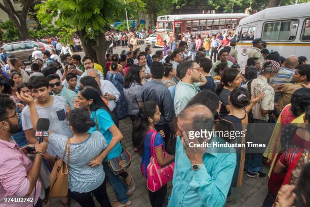 Residents outside the building as major fire broke out at BeauMonde Towers at Prabhadevi, on June 13, 2018 in Mumbai, India. Two firemen had to be...