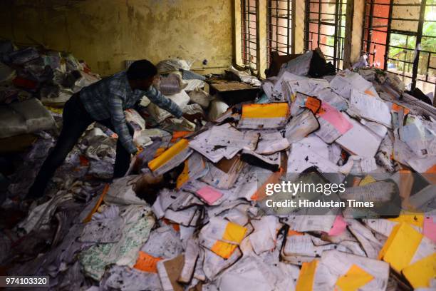 An RTO personnel inspects the papers which were damaged due to fire broke out on the first floor of the Regional Transport Office due to short...