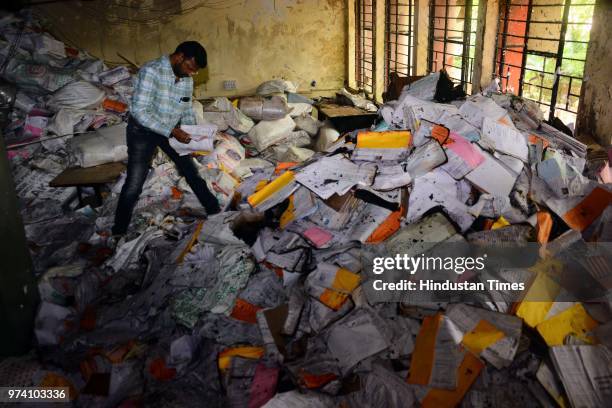 An RTO personnel inspects the papers which were damaged due to fire broke out on the first floor of the Regional Transport Office due to short...