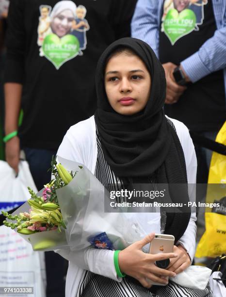 People arrive for the Grenfell Tower anniversary national minute silence and mosaic unveiling at the base of Grenfell Tower in west London to mark a...